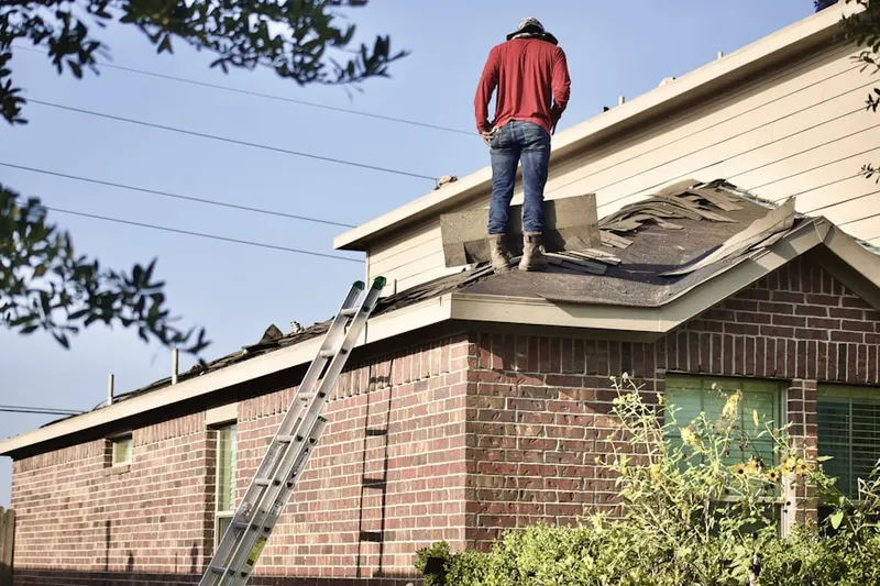 Professional roofer working on a residential roof in Atlantic Highlands